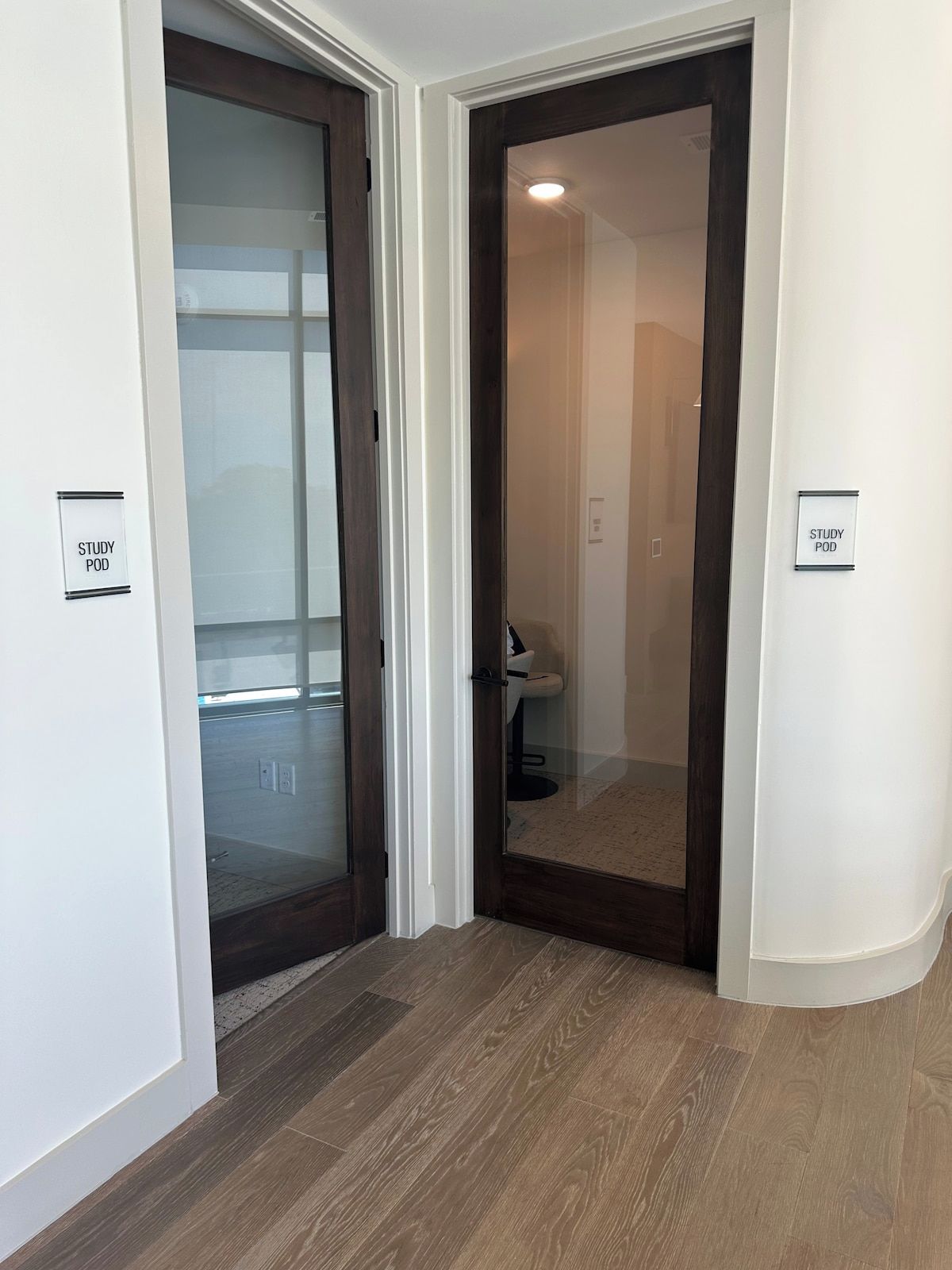 A hallway with two doors, one labeled 'STUDY POD' and the other 'STUDY POD' indicating study rooms.