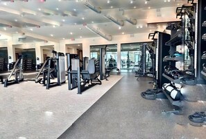 A modern gym with various exercise machines, mirrors, and a clean, well-lit environment. - Peaceful North Austin Retreat Near The Domain (Austin)