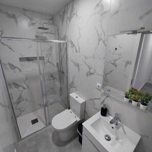 Shower, hair dryer, towels, toilet paper