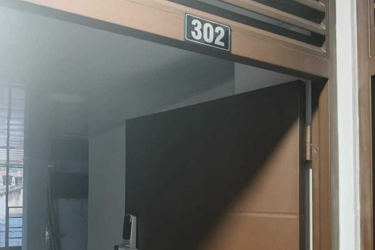 A door with a number plate '302' and a metal handle.