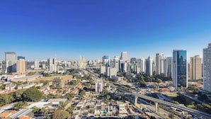 A cityscape with high-rise buildings, a bridge, and a mix of residential and commercial structures. - Apt w/ Balcony, Minutes From the Subway Ctb2405 (São Paulo)