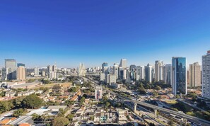 A cityscape with high-rise buildings, a bridge, and a mix of residential and commercial structures.