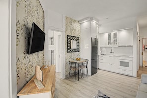 A modern kitchen with white cabinets, a built-in oven, and a stainless steel refrigerator. - Apartment Two Minutes from the Beach. Puerto Rico (Mogán)