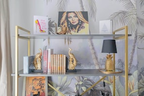 A bookshelf with decorative items, books, and a framed picture.