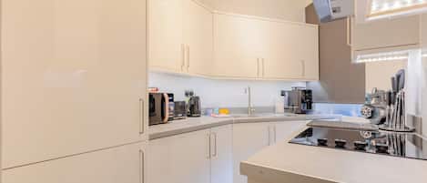 Coffee/tea maker, fridge, microwave, oven