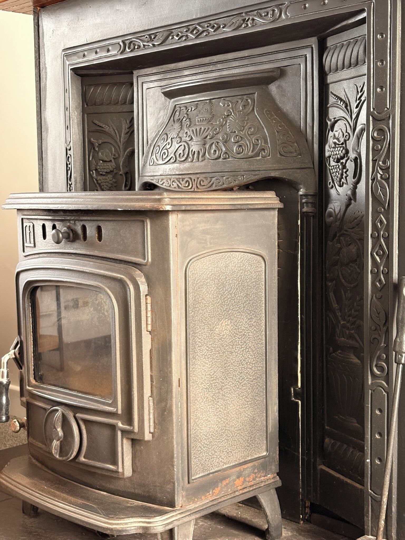 A vintage stove with a large oven door, a control panel with knobs, and decorative metalwork on the upper section.