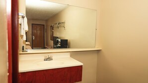 A bathroom with a white sink, wooden vanity, and a large mirror. -  Hotel Deerfield Inn & Suites Acworth Atlanta (Acworth)