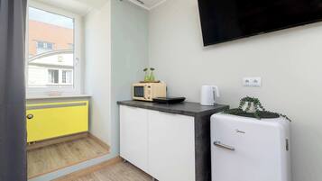 Kylskåp, mikrovågsugn, spishäll och grytor/köksredskap