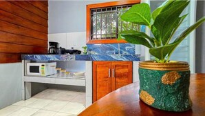 A kitchen with a microwave, a coffee maker, and a potted plant on the counter. - Private River - Nature Cabin Near La Fortuna (La Fortuna,)