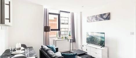 A modern living room with a sofa, coffee table, and TV.