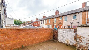 A residential area with terraced houses, a brick wall, and a gated entrance. - Preston PR2 Home | Ashton-on-Ribble | Parking (Lancashire)