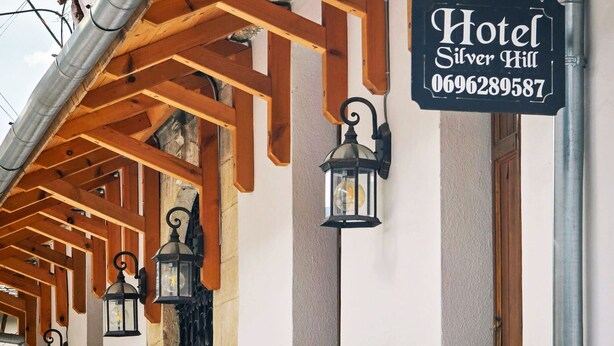 A hotel sign with the name "Hotel Silver Hill" and a phone number. - Silver Hill Guesthouse (Gjirokastër)