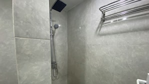 A shower with a handheld showerhead and a wall-mounted faucet. - Vang Vieng Golden Lotus Hotel (Vang Vieng)