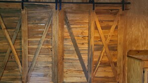 A wooden interior with a slatted ceiling design.