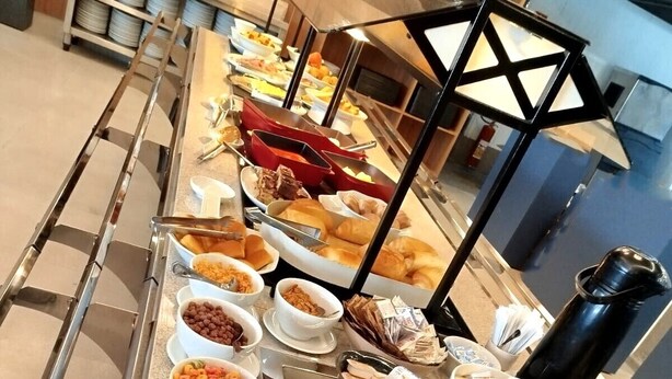 A buffet setup with various food items and beverages.