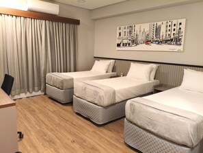 Deluxe Triple Room | In-room safe, desk, laptop workspace, iron/ironing board