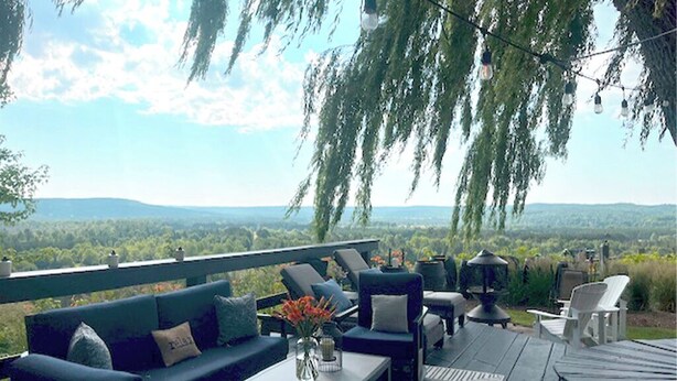 An outdoor seating area with a view of the landscape.