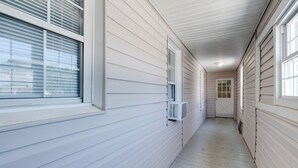 A narrow hallway with white siding walls and a wooden floor. - Near Loudoun Wine Trail: Apt w/ Restaurant On-Site (Hamilton)