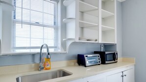 A kitchen with a sink, a window with blinds, a microwave, and a toaster. - Near Loudoun Wine Trail: Apt w/ Restaurant On-Site (Hamilton)