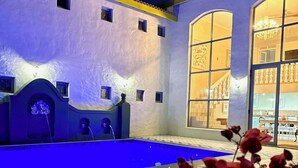 A courtyard with a pool, a fountain, and a large window overlooking a garden. - Grande Casa (Stellenbosch)