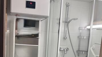 Shower, hair dryer, towels, toilet paper