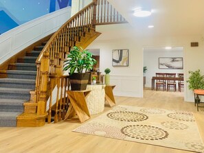 A staircase with wooden railings leading to a dining area with a table and chairs. - Amazing Unique House in Richmond Hill/25+ (Richmond Hill)