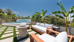 An outdoor seating area with a pool, a sofa, and a table. - NEW!!! Ocean View Malibu Modern Home w/ Mini Golf & Spa (Malibu)