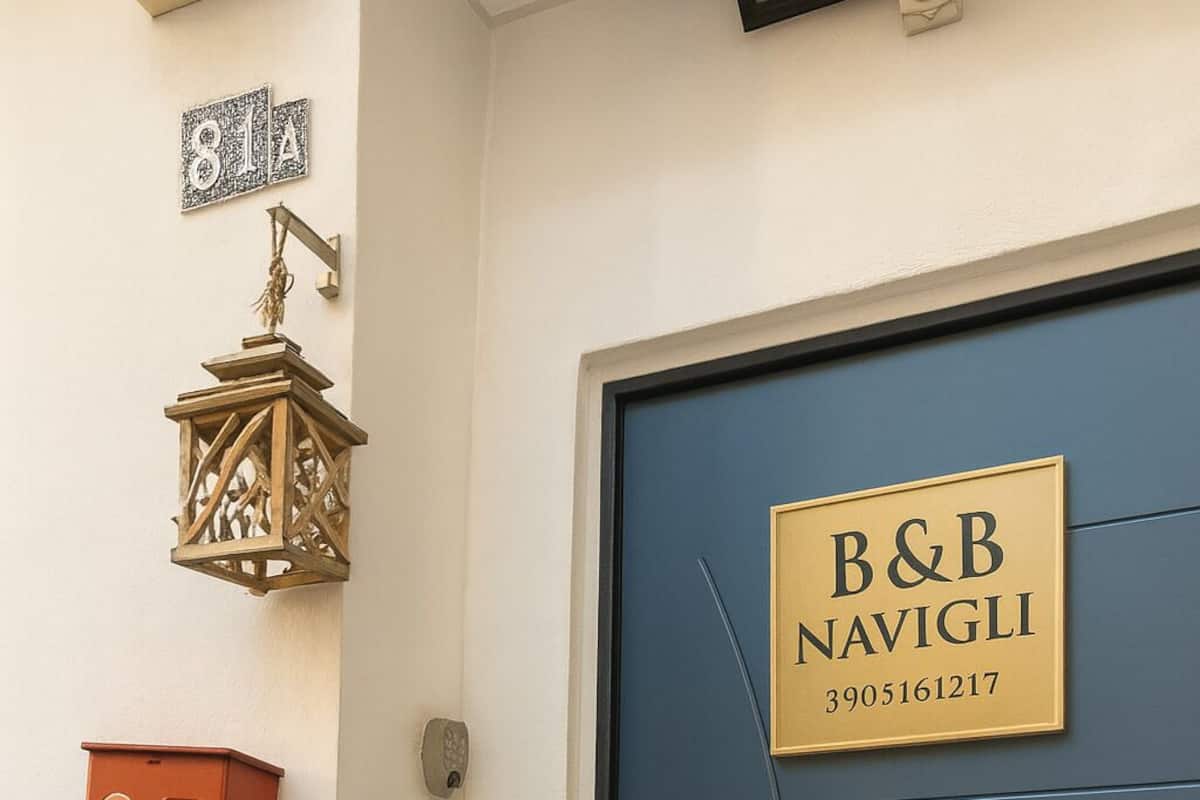 A blue door with a sign reading "B&B NAVIGLI 3905161217".