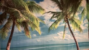 A beach scene with palm trees and a clear sky. - 6a Scotia Place (Auckland)