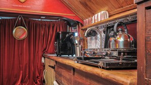 A vintage train dining car with a red interior, wooden paneling, and a coffee machine. - Dashing Dennis - 22 (Launceston)