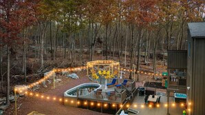 A deck with a pool, outdoor seating, and a gazebo. - WOW Pocono Private Heated Pool, Pickleball, Hottub (East Stroudsburg)