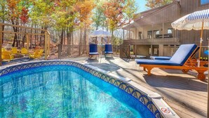 A swimming pool with a wooden deck, lounge chairs, and a gazebo. - WOW Pocono Private Heated Pool, Pickleball, Hottub (East Stroudsburg)