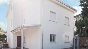 A two-story building with a covered entrance and a small porch. - 1 bedroom awesome apartment in Capaccio Paestum (Capaccio Paestum)