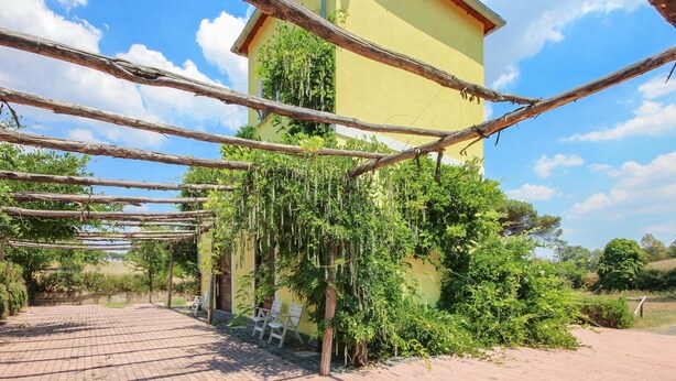 A yellow building with a brick pathway leading to white chairs. - Awesome home in Roma with WiFi (Roma)