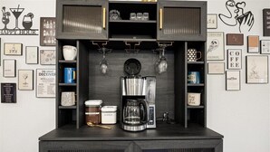A coffee station with a coffee maker, sugar, and milk containers. - 3 bedroom, 2 bath house, sleeps 6+, baby bed W (Hood County)