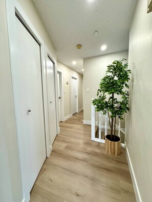 A hallway with wooden flooring, white walls, and doors. - Fabulous 1-bedroom in Surrey, British Columbia, Canada (Surrey)