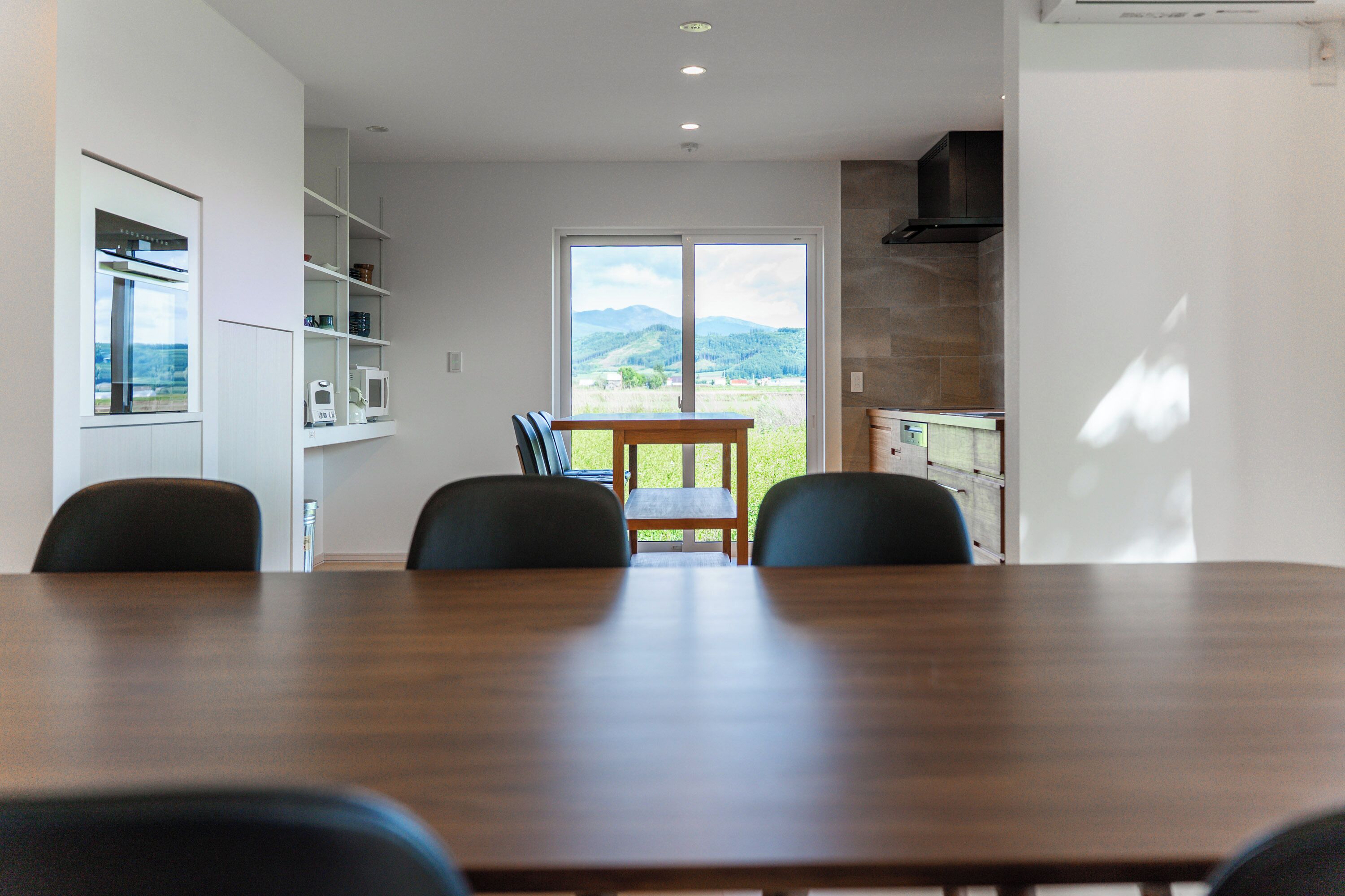 A modern kitchen with a dining area.
