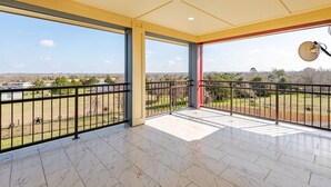 A spacious balcony with a clear view of the surrounding landscape.
