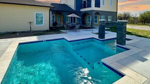 A two-story house with a swimming pool.