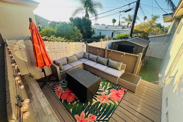 Firepit table, and lounge area with fairy garden twinkle lights