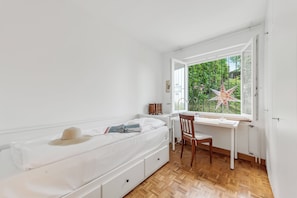Ein Schlafzimmer mit einem Bett, einem Schreibtisch und einem Stuhl.