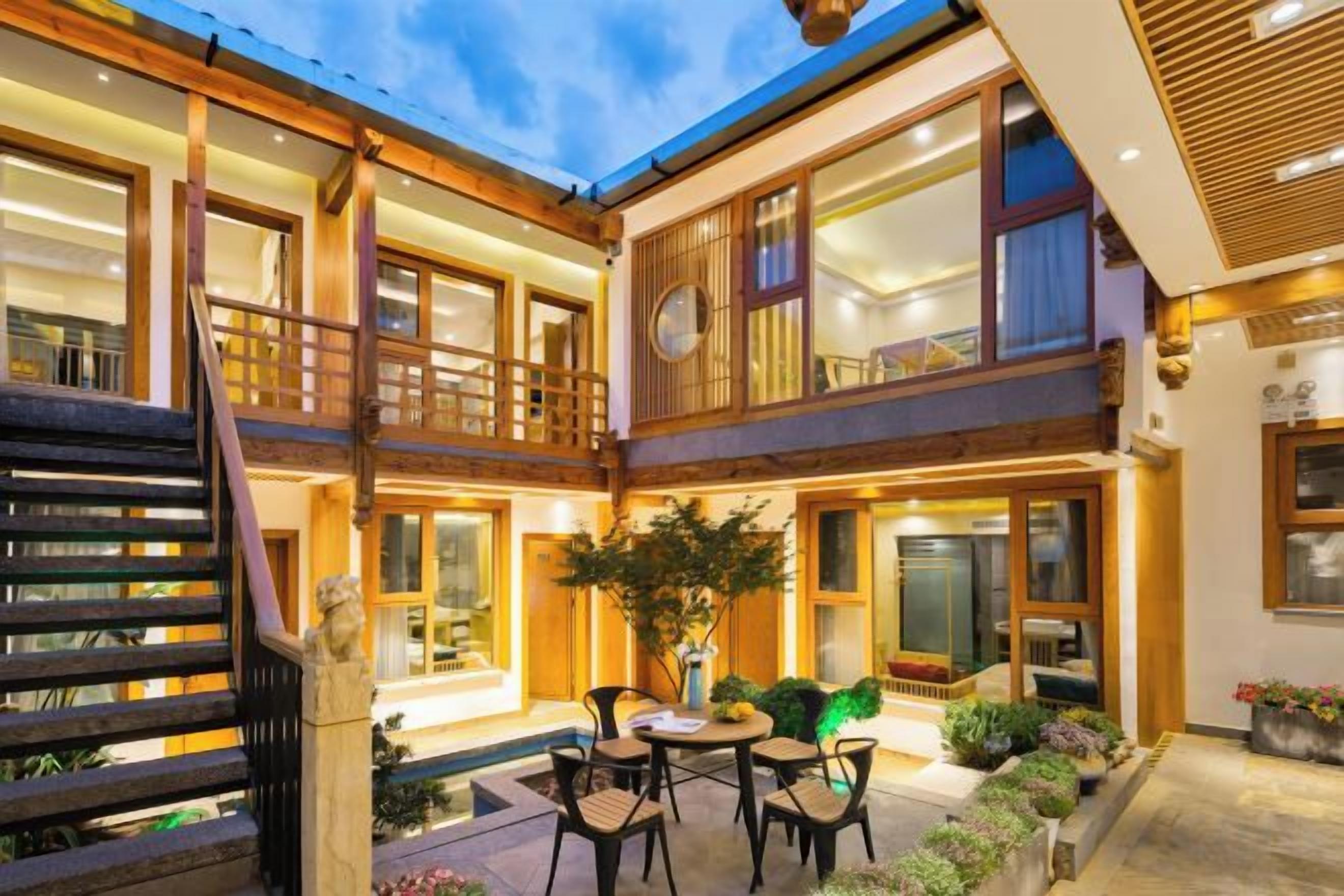 A multi-story building with a courtyard, outdoor seating, and a staircase.