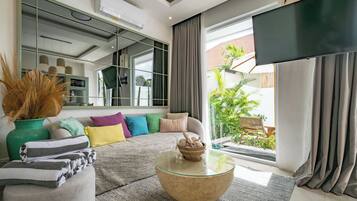 Deluxe Villa, 2 Bedrooms, Patio, Pool View | Living room | 50-inch TV with cable channels