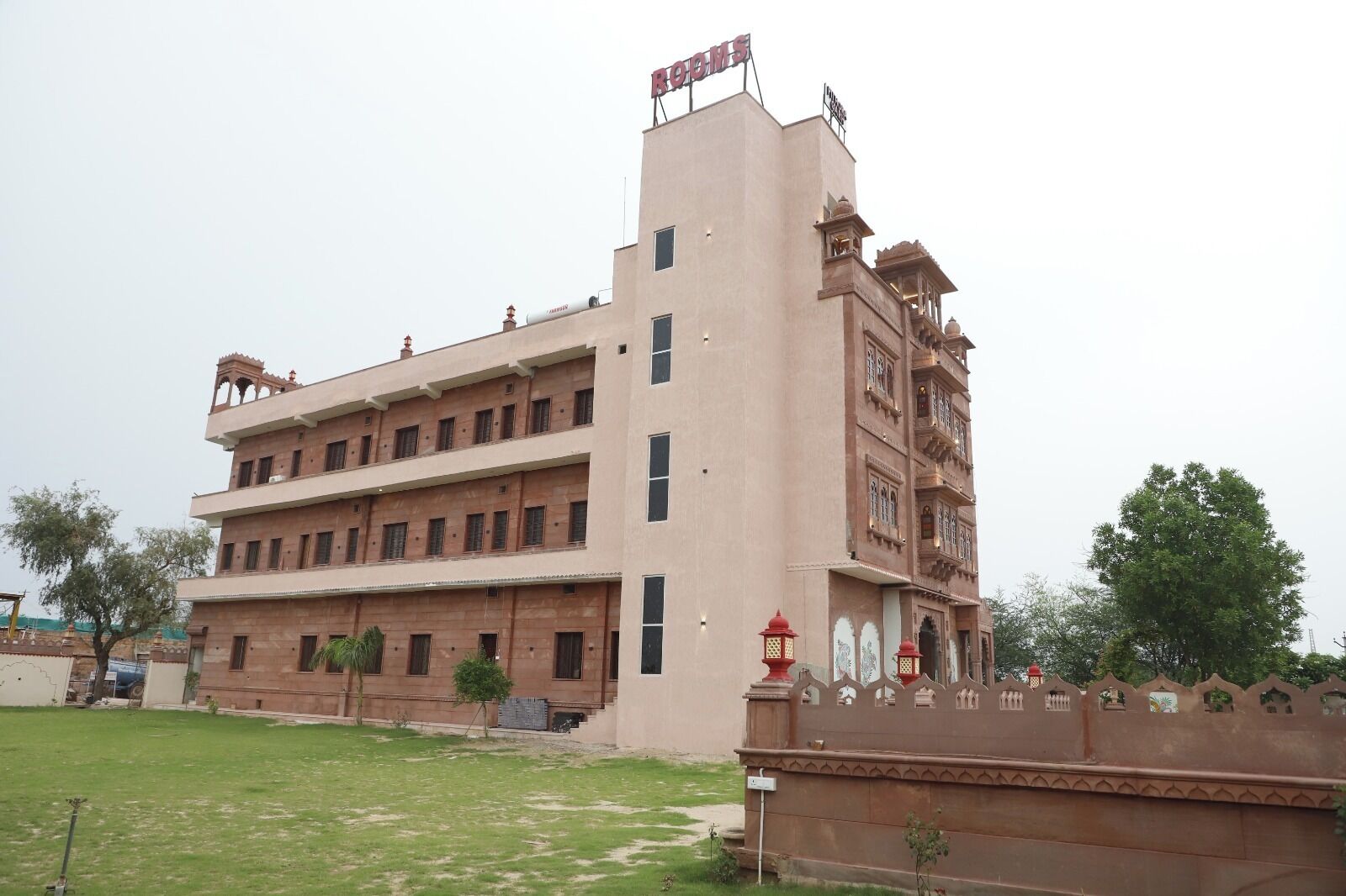 A multi-story building with a flat roof and a sign that reads "BASINS".