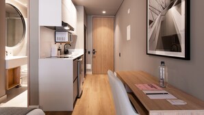 A modern kitchen with a built-in microwave, a wooden door, and a dining area with a bench and table.
