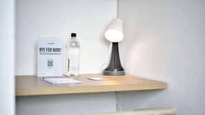 A desk with a lamp, a bottle, and a sign. - w Stunning Loft in Bogota (Bogotá)
