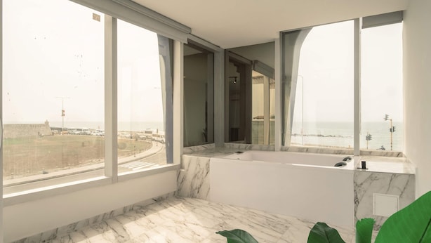 A modern bathroom with a large bathtub, marble flooring, and large windows offering a view of the sea. - w Great 2BR w Ocean View Near C Amurallada (Cartagena)