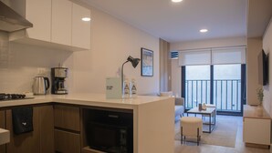 A modern kitchen with a coffee maker, microwave, and a welcome sign. - w Stunning 1BR w Terrace in Miraflores (Lima)