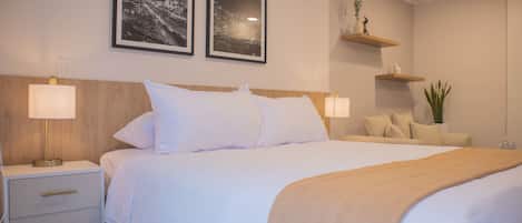 A neatly arranged bedroom with a bed, bedside tables, and wall-mounted shelves.