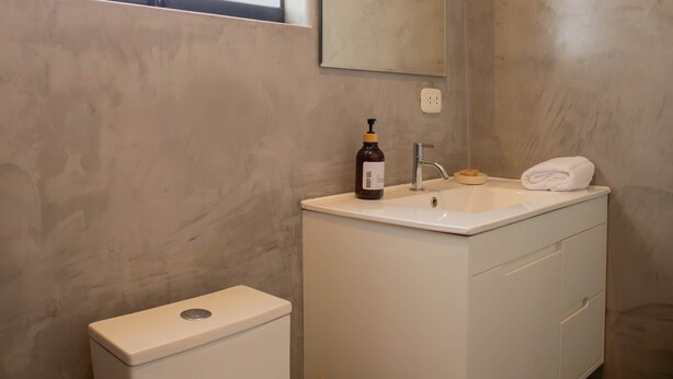 A bathroom with a white sink, a mirror, and a toilet. - w Impressive 5BR w Terrace in Miraflores (Lima)